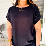 Woman wearing a black t-shirt in an outdoor setting