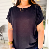 Woman wearing a black t-shirt in an outdoor setting