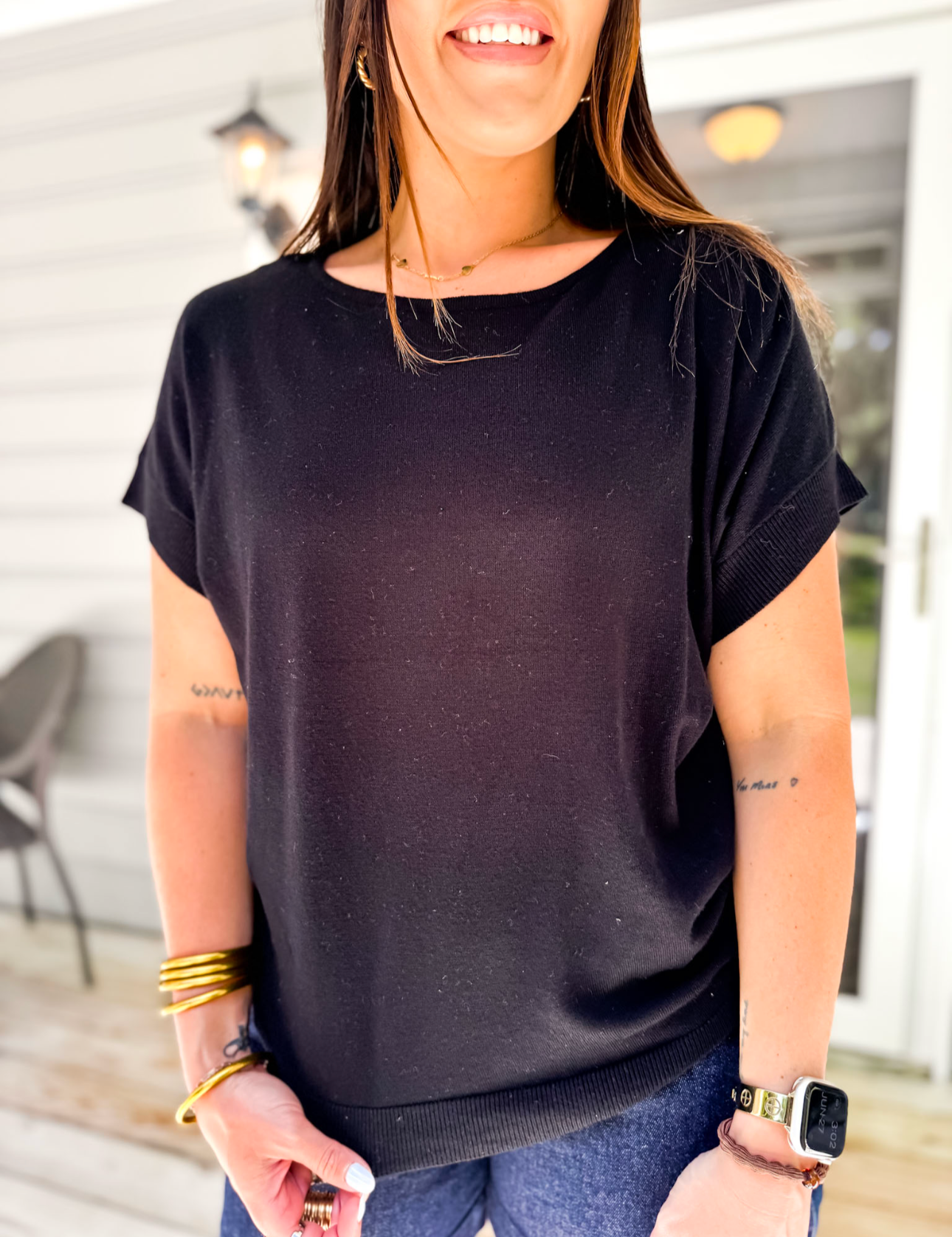 Woman wearing a black t-shirt in an outdoor setting